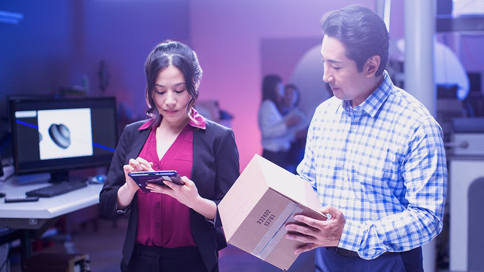 Two small business owners in an office sending Parcel.