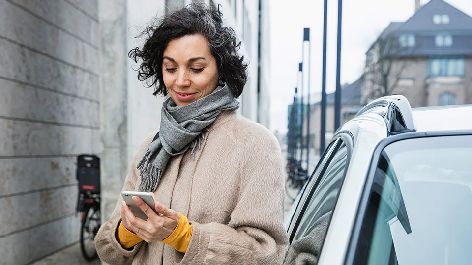 Woman in street looking at phone